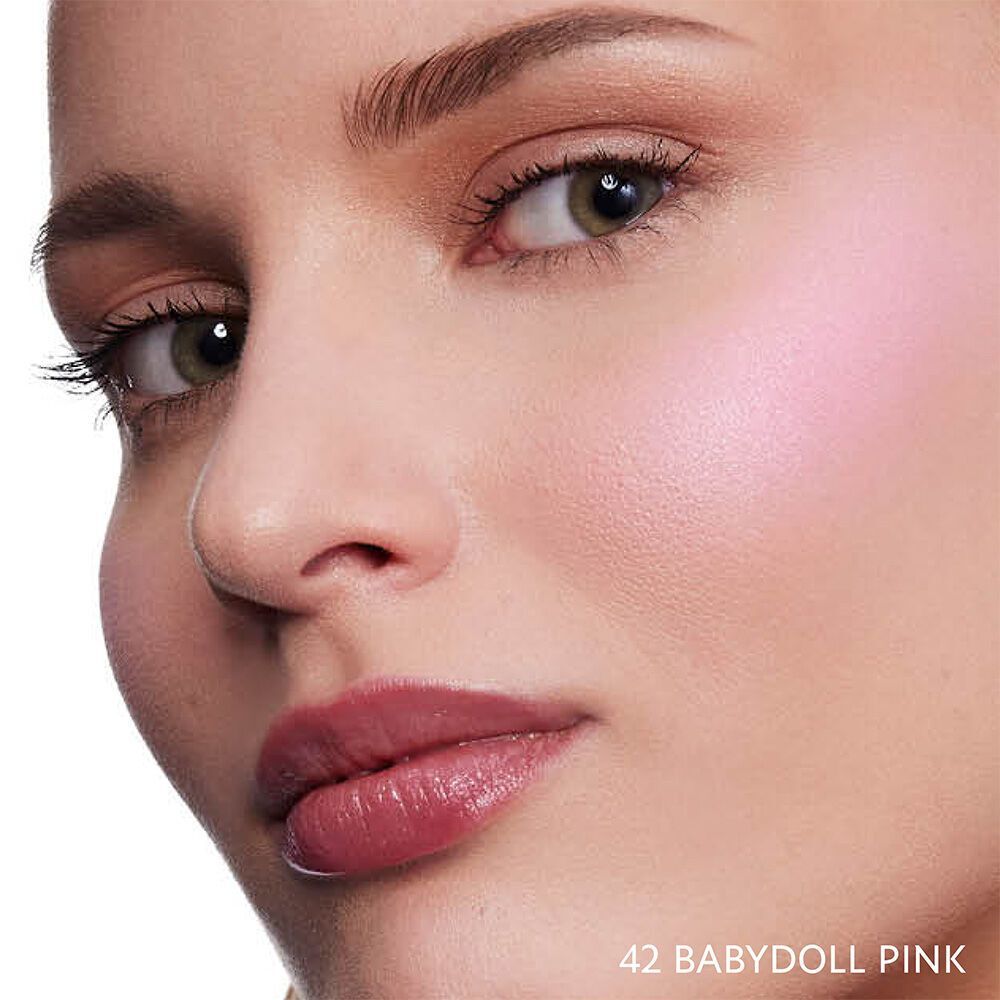 Close-up of a model wearing YSL Make Me Blush Bold Blurring Blush in shade 42 Babydoll Pink, showcasing a radiant, soft pink glow on her cheeks