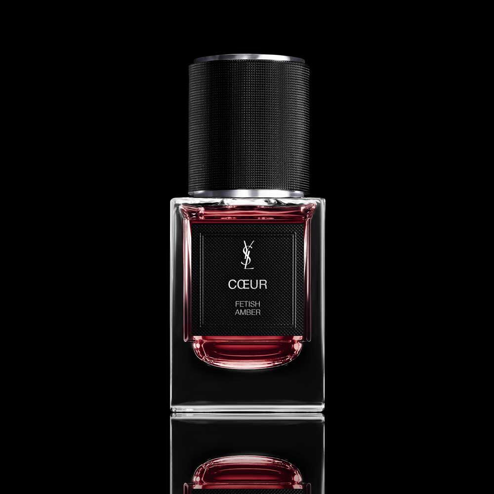 COEUR Eau de Parfum ruby-red bottle with black cap on a reflective YSL background.