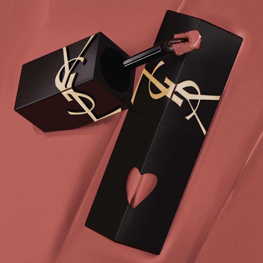 YSL The Inks Blur lip stain tube and applicator placed on a background, highlighting the shade and design.