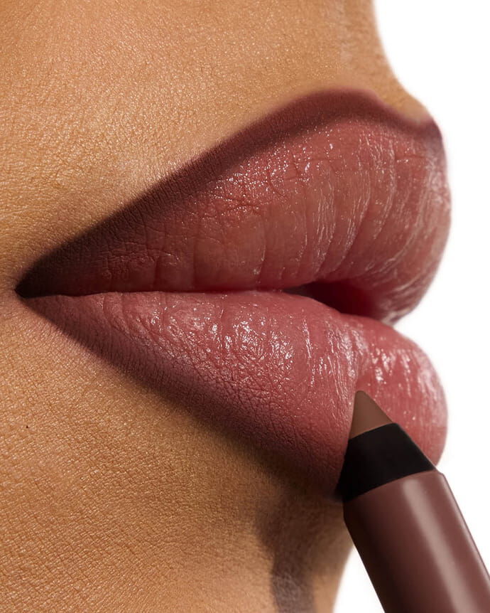 Ehlana wearing YSL LOVENUDE Kiss Shaper, shade 110, on medium skin. Portrait close-up.