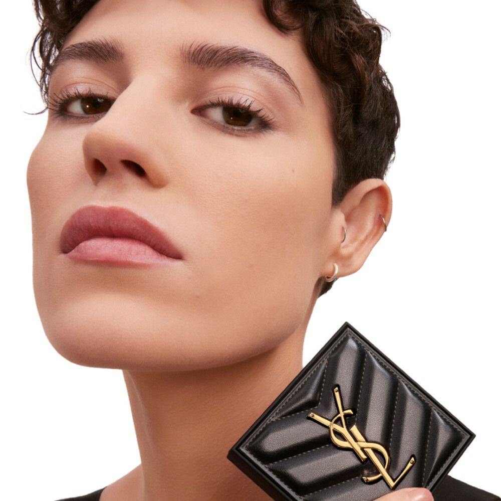 Model holding YSL All Hours Hyper Finish Powder compact, showcasing a shine-free complexion