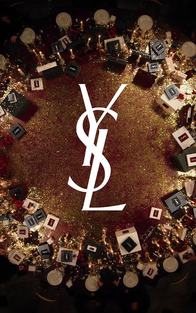 Video of guests at a festive YSL dinner, sharing joy and gifting luxury holiday sets in a decadent atmosphere.