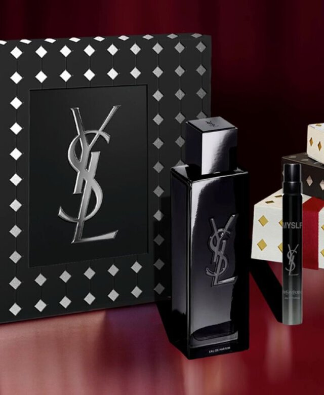 YSL MYSLF EDP bottles stacked on black, white, and gold Holiday gift boxes.