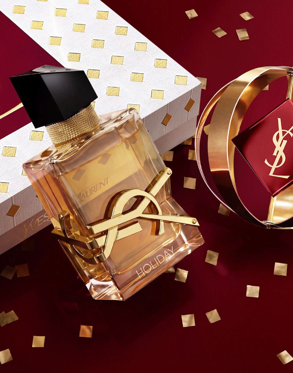 YSL LIBRE Eau de parfum alongside iconic gold and burgundy Holiday gift packaging.