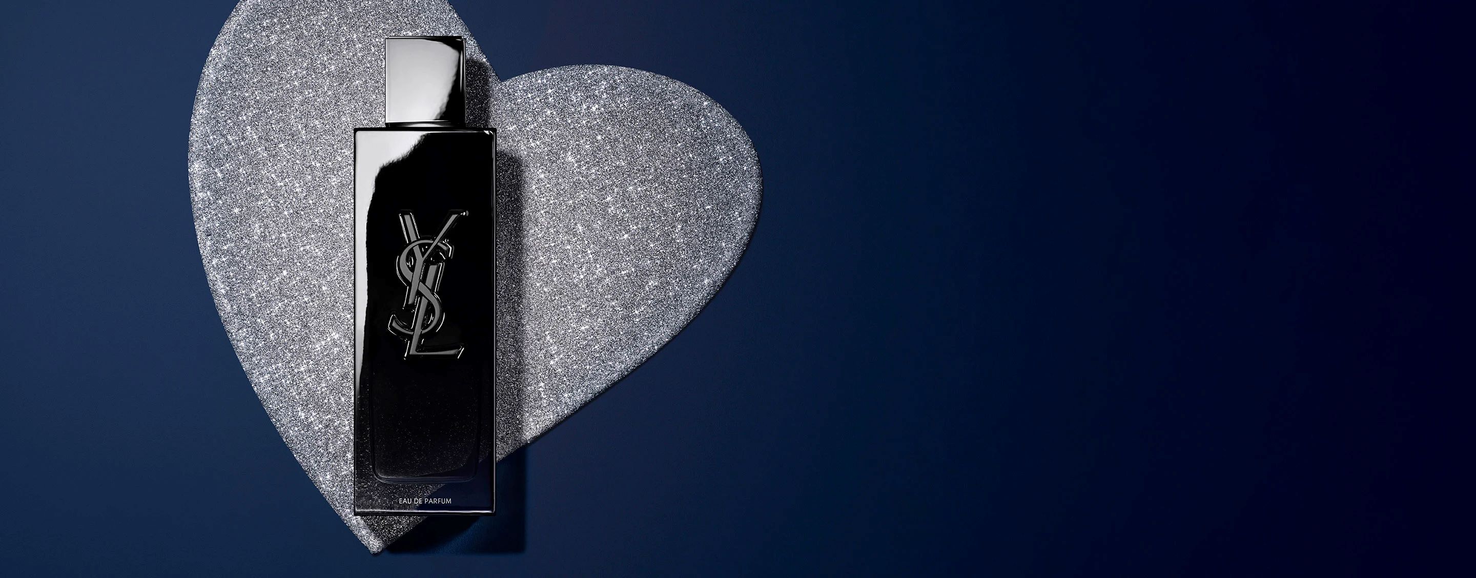 YSL MYSLF Eau de Parfum 100ml bottle, black with embossed YSL logo, on a glittery silver heart background.