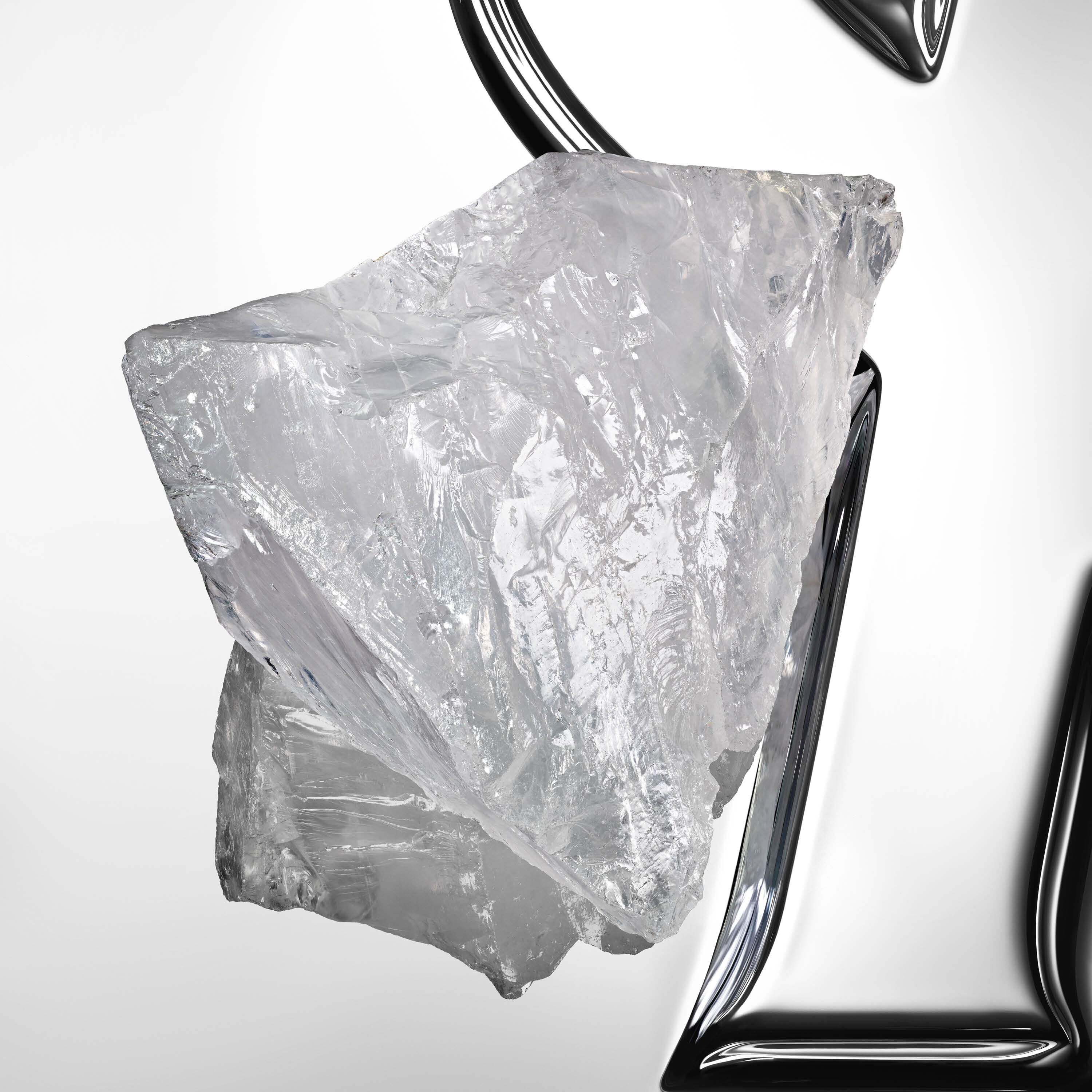 Compelling white musk crystal block on a reflective YSL Cassandre background.