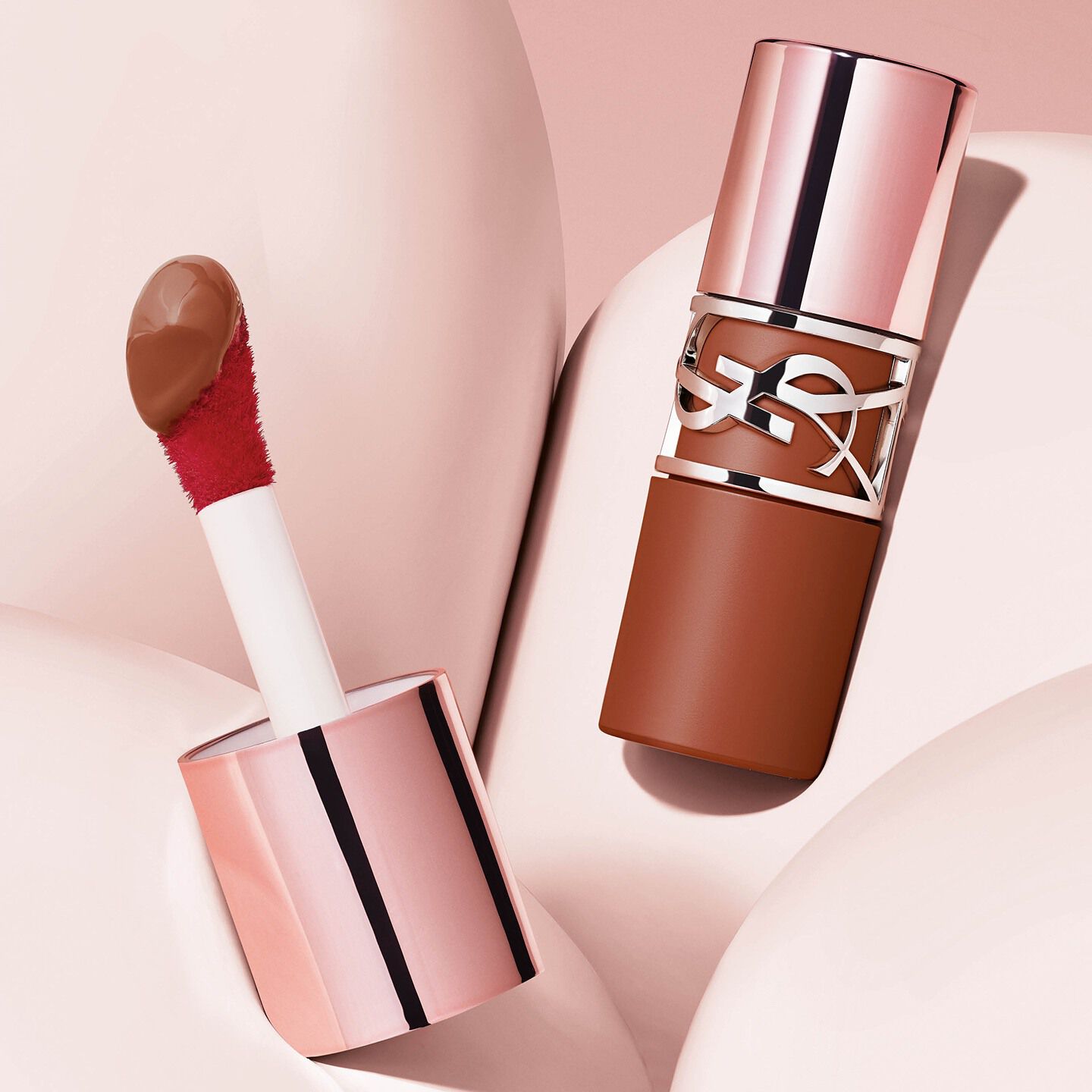 Detailed YSL LOVENUDE LIP STAIN bottle
with signature wide applicator and serum
texture on pink backgraound