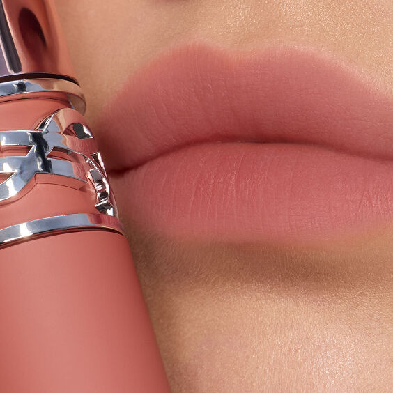 Macro close-up of soft-blurred, nude pink
lips.
